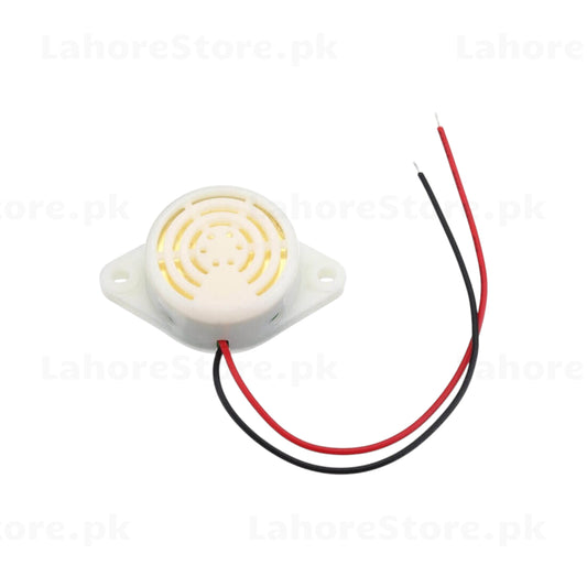 Active piezo buzzer top view showing concentric ring grille with red and black wire leads