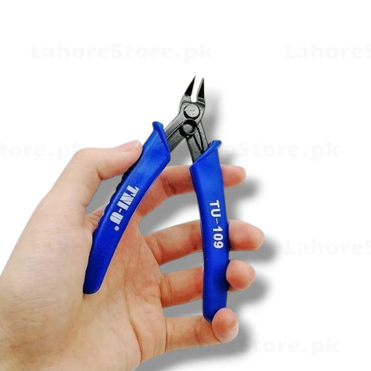 TNI-U TU-109 flush cutter held in hand showing blue ergonomic handles, spring-loaded mechanism and precision thin-profile blades