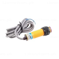 E18-D80NK infrared proximity sensor yellow M18 cylindrical body with 3-wire cable front view showing IR lens